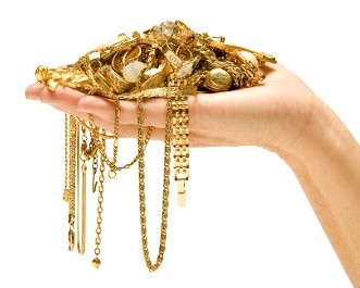 Hand Holding Various Gold Jewelry